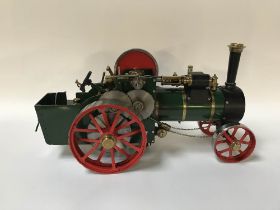 A small spirit fed live Bassett Lowke traction steam engine, in green livery, 38 x 17cm (cased)