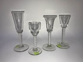 Four Georgian opaque air twist wine glasses, one with acid etched decoration
