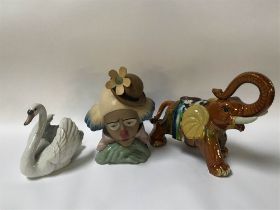 A Lladro bust of a Clown, number 2350, a Lladro Swan and a Majolica Elephant (3)