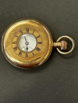 Gold plated half hunter pocket watch currently tic