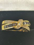 9ct Gold crossover ring set with sapphires & diamo