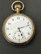 Gold plated open face pocket watch currently ticki