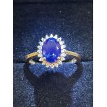 18ct Gold ring set with central sapphire surrounde