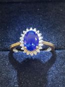 18ct Gold ring set with central sapphire surrounde