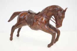 Old leather galloping horse in the style of Liberty