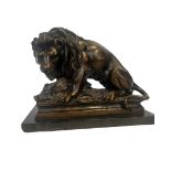 Heavy bronze lion with prey sat on a marble base,