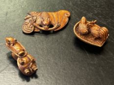 Three finely carved wooden netsuke figures, all signed