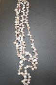 A silver clasp necklace of pearl stones