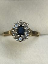 9ct Gold ring set with central sapphire surrounded