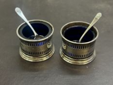 A pair of silver salts with blue liners & spoons