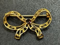 Yellow metal pin brooch tested for high carat gold