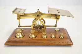 Set of early 20th century brass postage scales wit