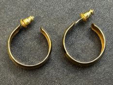 Pair of yellow metal hoop earrings tested for high