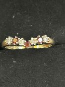 9ct Gold wishbone ring set with garnets & cz stone