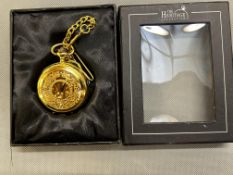 Gold coloured manual wind pocket watch on chain wi