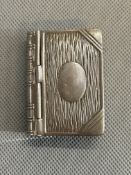 White metal stamp holder in the form a book