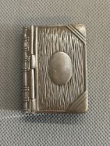 White metal stamp holder in the form a book