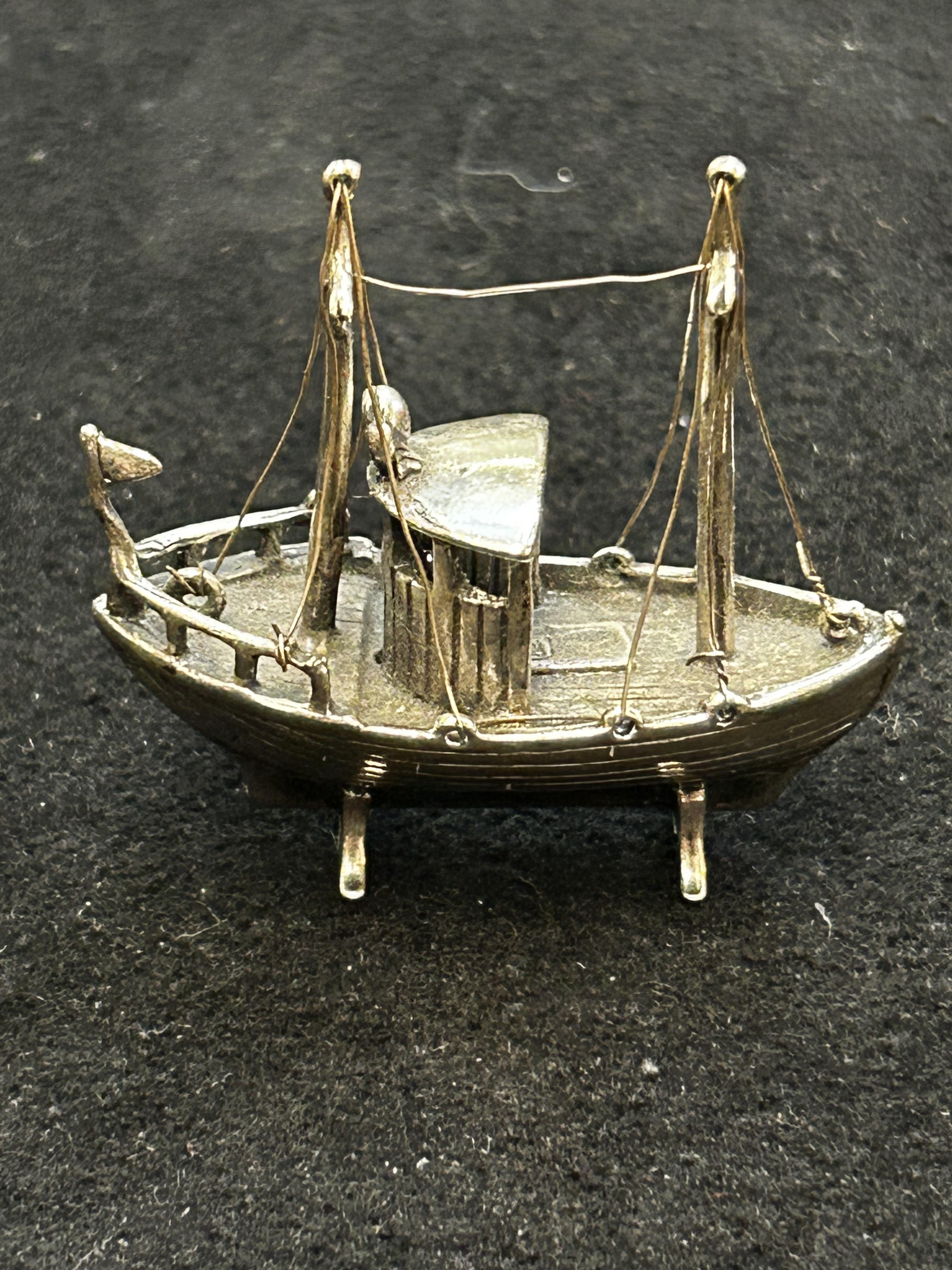 White metal boat, possibly silver