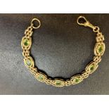 9ct Gold bracelet set with 7 possibly peridot ston