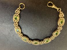 9ct Gold bracelet set with 7 possibly peridot ston