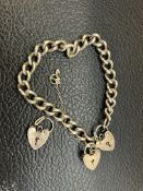 Silver charm bracelet with 3 heart shaped lockets