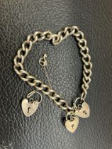 Silver charm bracelet with 3 heart shaped lockets