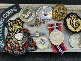 Collection of military medals, cap badges, brooche