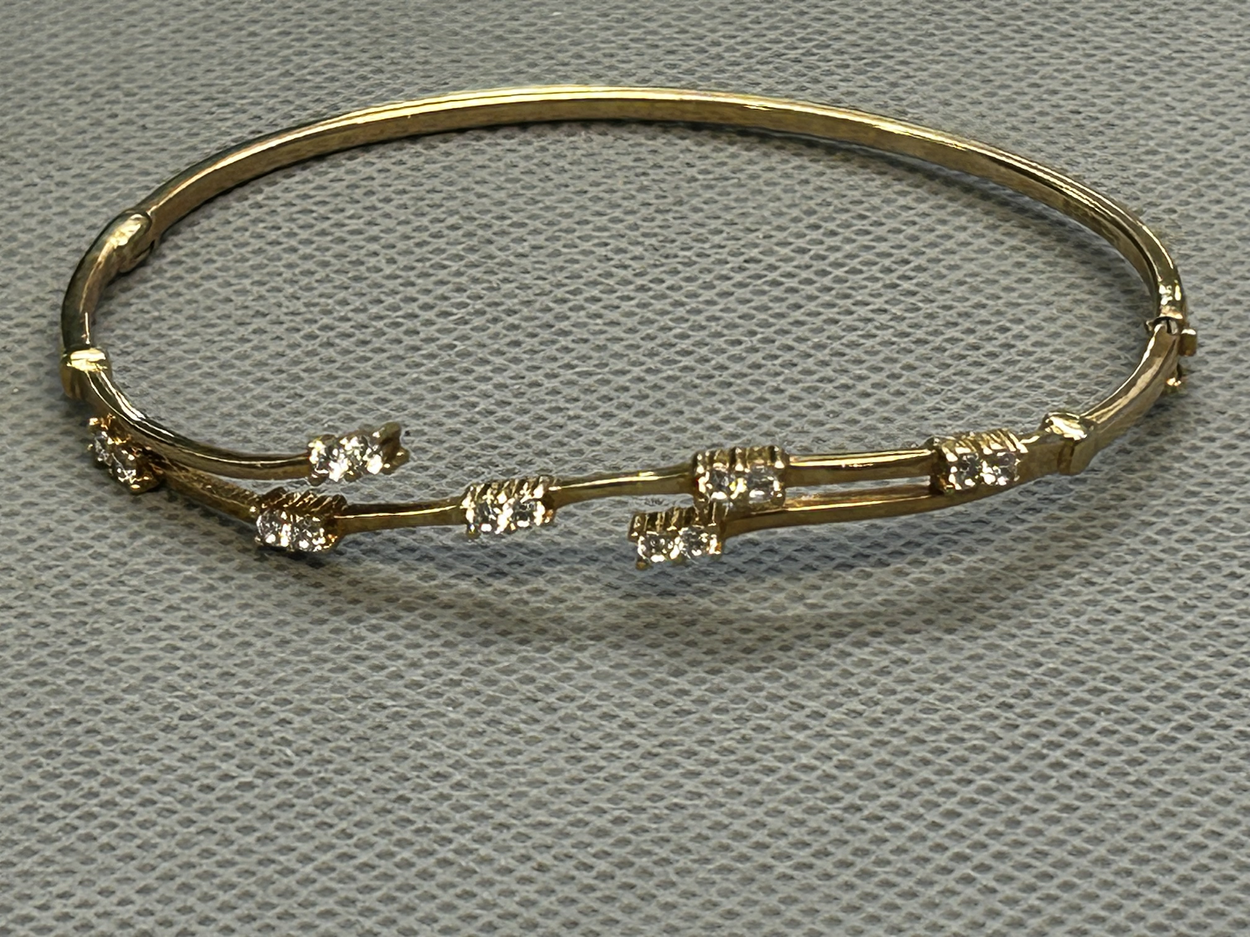 9ct Gold bangle set with 14 white stones Weight 6.