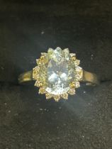 9ct Gold ring set with clear blue stone surrounded