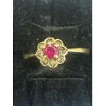 9ct Gold ring set with central red stone surrounde