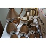 Collection of copper measuring jugs