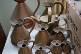 Collection of copper measuring jugs