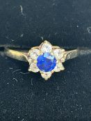9ct Gold ring set with central blue sapphire surro