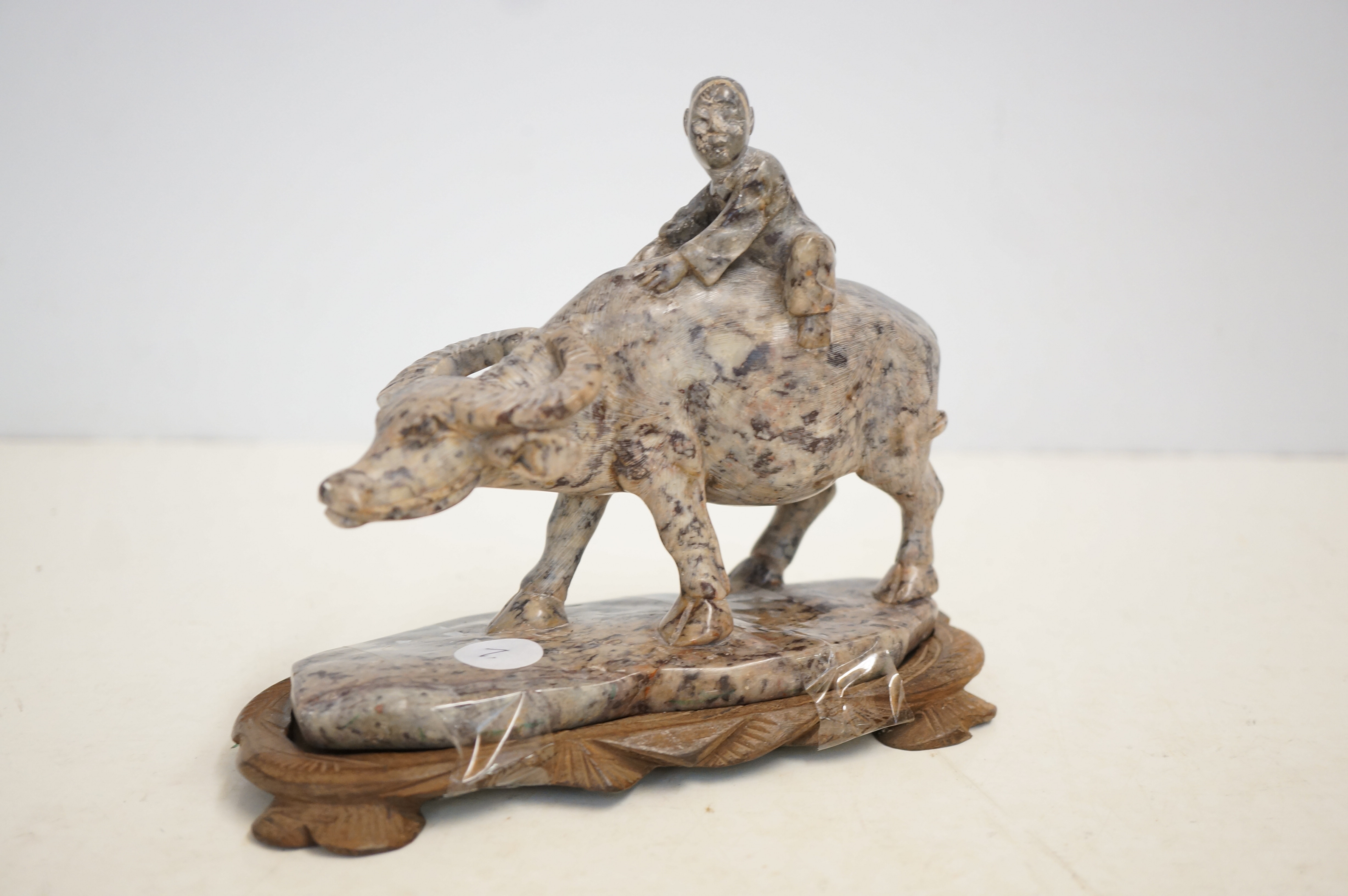 Oriental figure of a Chinese man on water buffalo