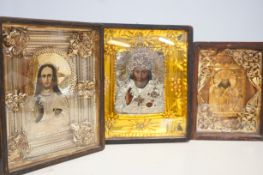 Three religious cased icons, tallest 35cm