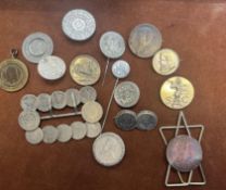 Collection of coins all made into brooches and pen