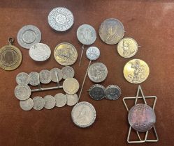 Collection of coins all made into brooches and pen