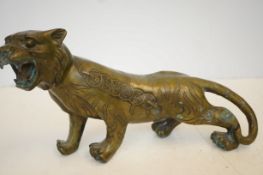 Bronze model of a tiger with Chinese writing, 36cm