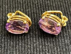 Pair of 9ct gold clip on earrings set with amethys