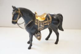 Bronzed horse with sadle