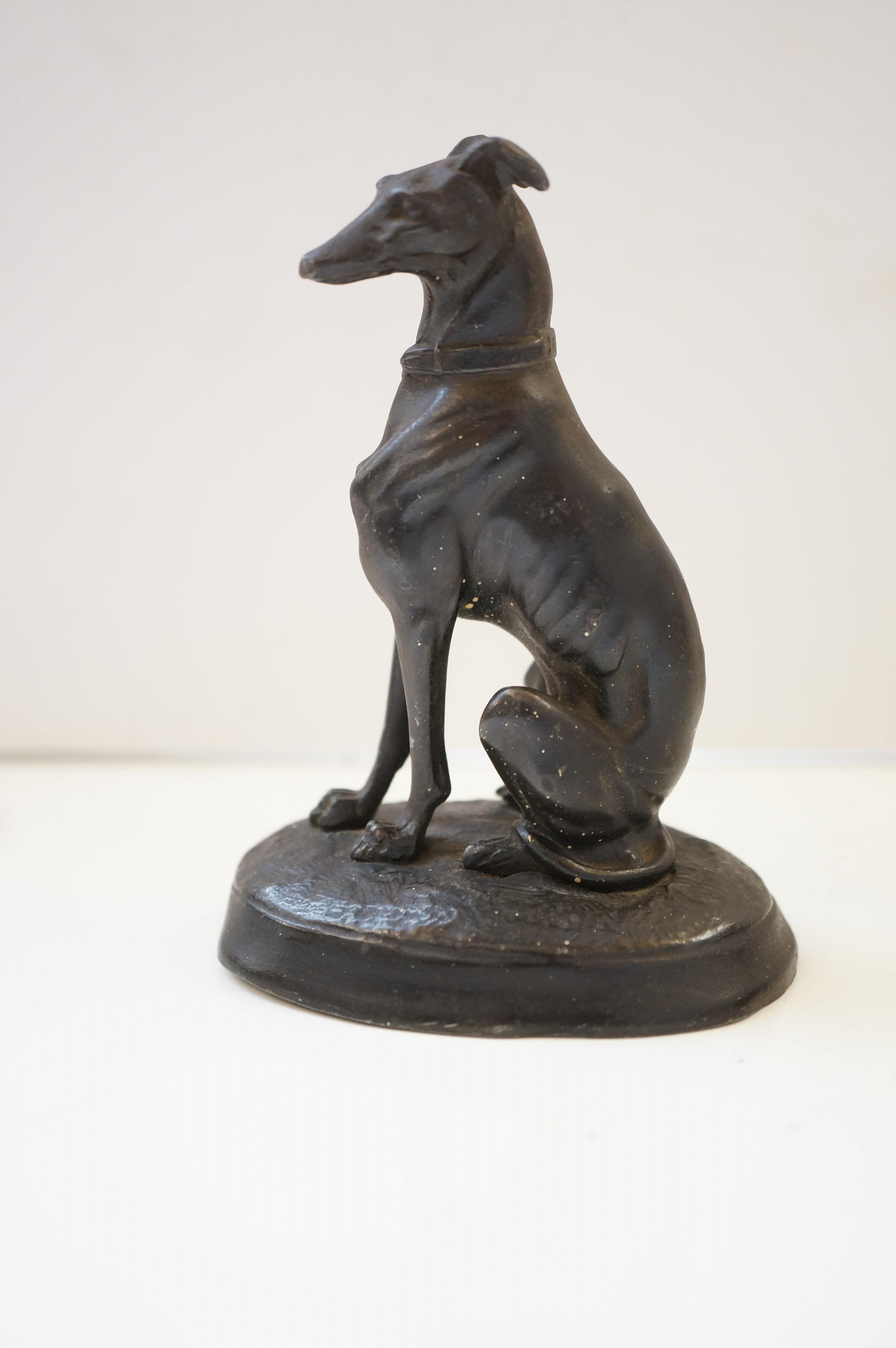 Metal greyhound sitting signed