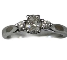 Platinum ring set with central oval cut diamond wi