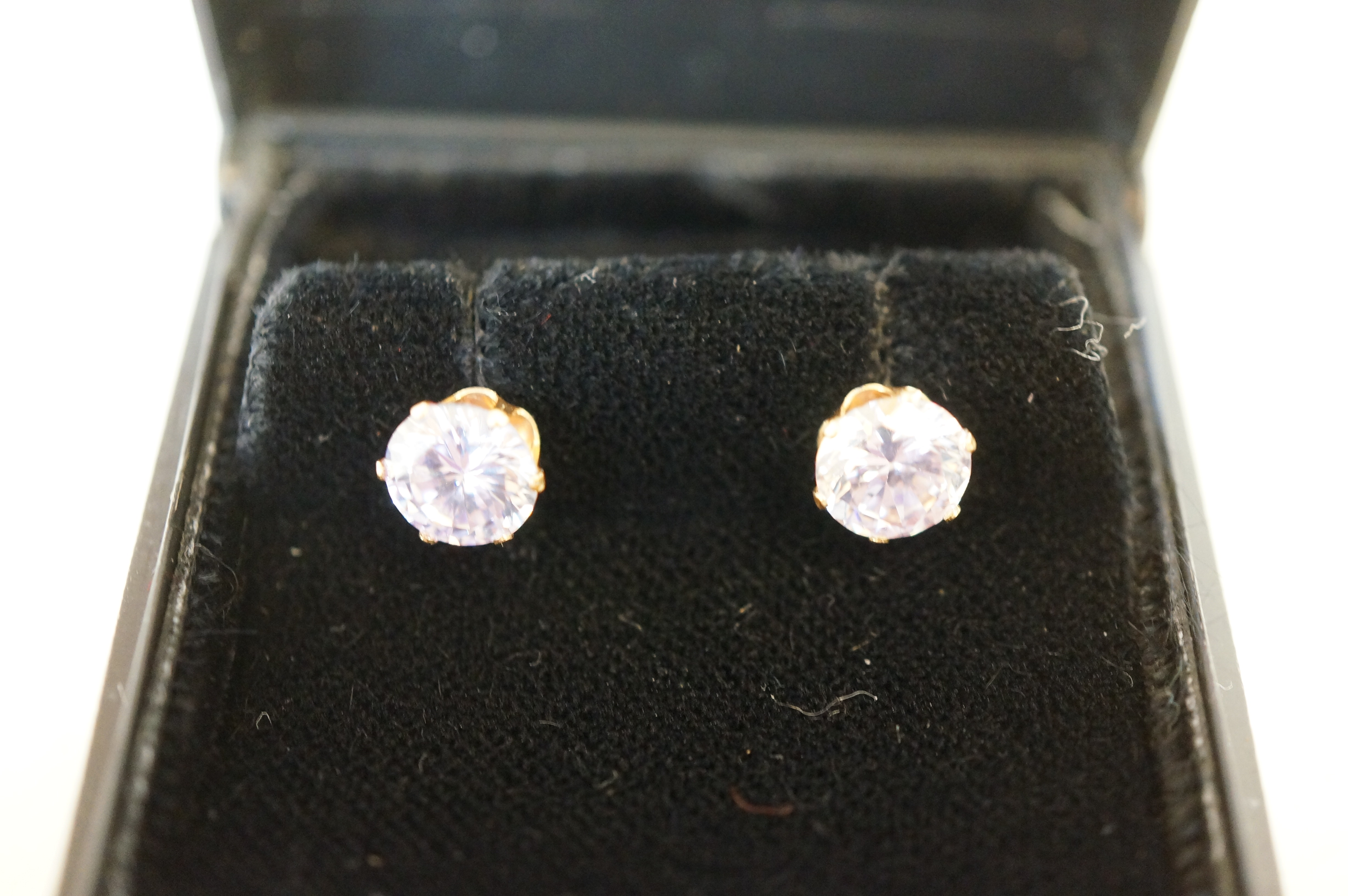 Boxed pair of 9ct gold solitaire earrings