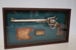 Shadow box with model revolver, bullets & reciept