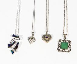 Four silver pendants and chains and a silver locket