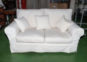 A two seater sofa with loose covers