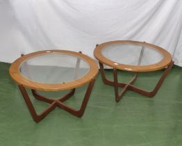 A pair of retro coffee tables with glass tops.