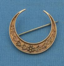 A crescent brooch tested for 15ct gold