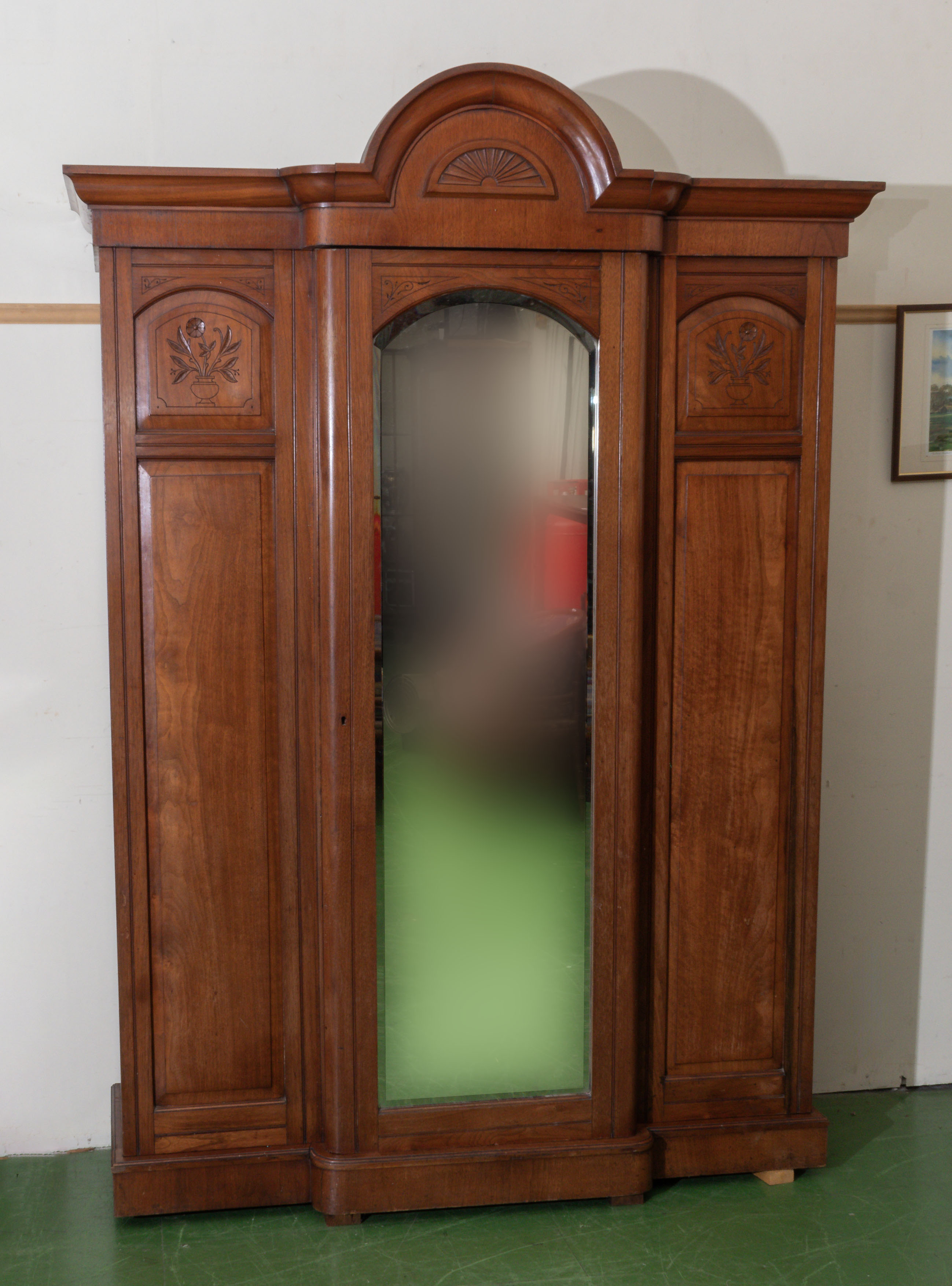 A good Victorian mahogany wardrobe with dome crest centre, mirror door, panel sides with carved