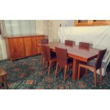 A 20th century contemporary dining table and six chairs together with matching sideboard.